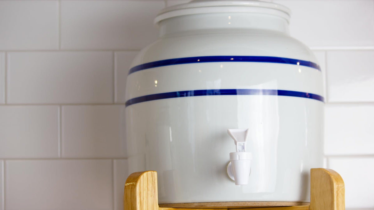 New Wave Enviro porcelain water dispenser blue stripe design enhances kitchen aesthetics.