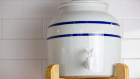 New Wave Enviro porcelain water dispenser blue stripe design enhances kitchen aesthetics.