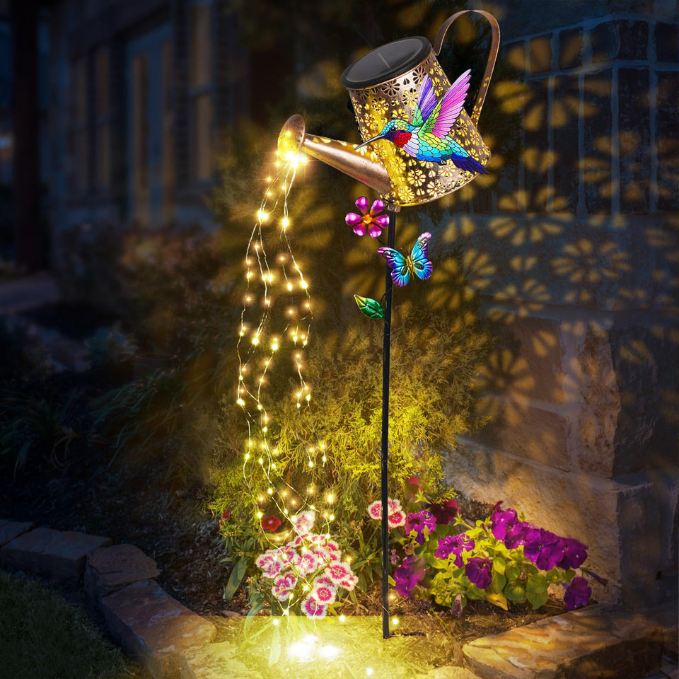 Newinhome solar watering can lights illuminate the garden at night.