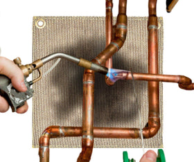 Newtex PlumberPad 12x12 heat protection demonstrates heat resistance up to 1800°F