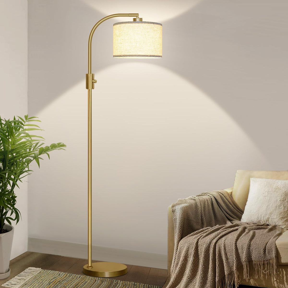 Nintiue arc floor lamp with gold linen shade illuminating a cozy corner
