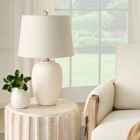 Nourison Home 23in ceramic jar lamp with urn silhouette adds warm ambient light for living spaces.