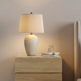 Nourison Home ceramic jar lamp with ivory shade creates cozy bedroom ambience.