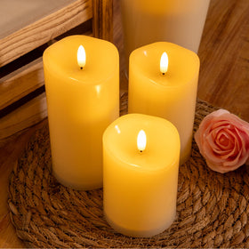 NURADA ivory candles lit on a garden table emphasize ambience.