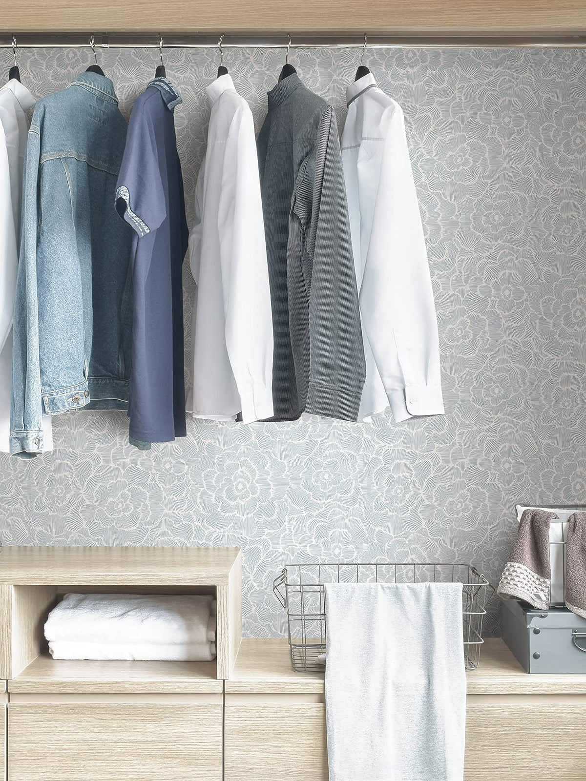 NuWallpaper Saraya blue floral repositioning indicates easy adjustments during installation.
