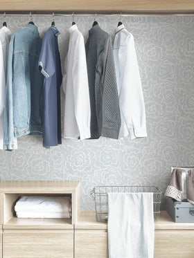 NuWallpaper Saraya blue floral repositioning indicates easy adjustments during installation.