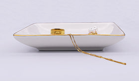 NZY bridal gift tray on nightstand holds rings and earrings neatly.