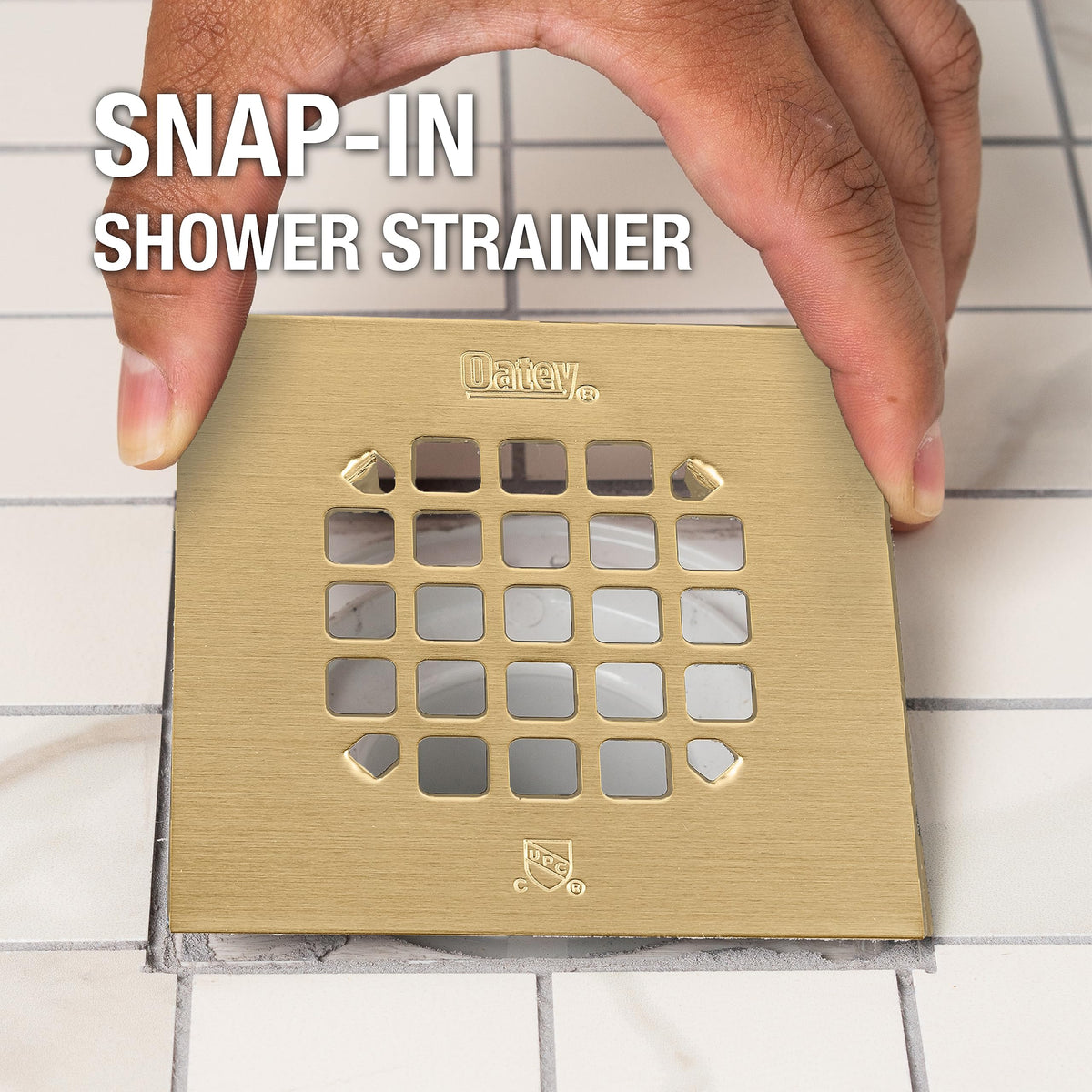 Oatey square drain strainer with brushed gold finish to match fixtures.