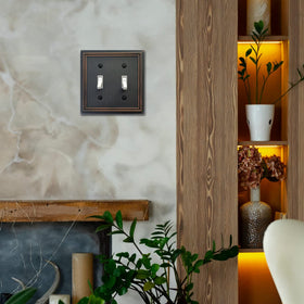 OKAWYC Adler aged bronze finish complements lighting fixtures and cabinetry.