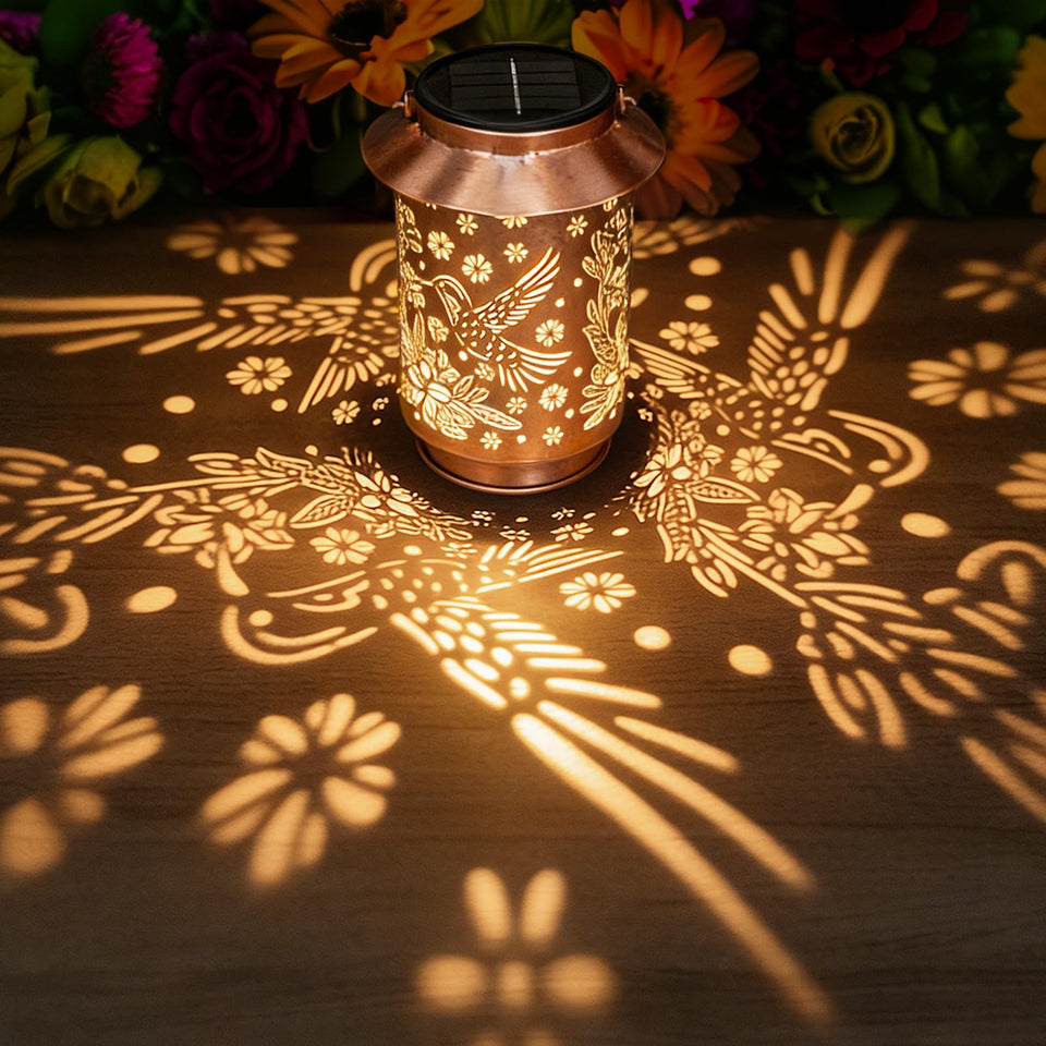 Ollny solar hummingbird lantern lights garden with warm decorative glow.
