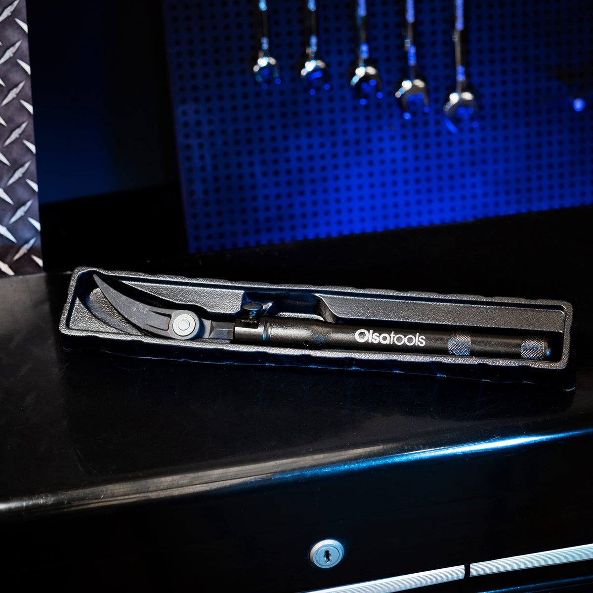 Olsa Tools pry bar ready for garage or industrial tasks in a workshop.