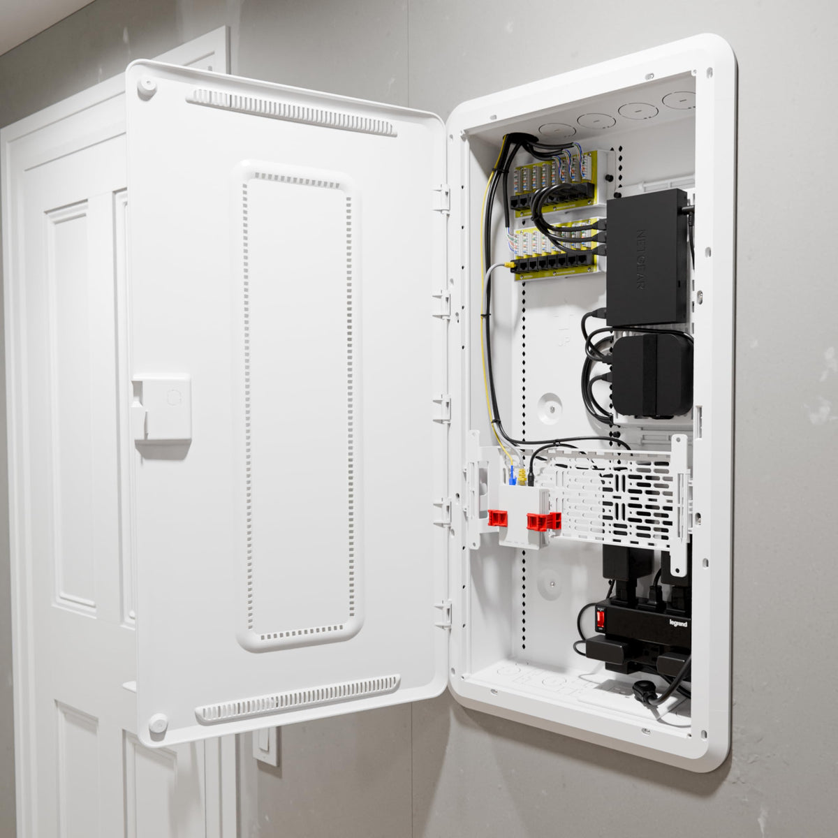 Interior view of On-Q enclosure with universal mounting grid ready for devices.