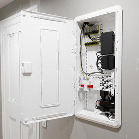 Interior view of On-Q enclosure with universal mounting grid ready for devices.