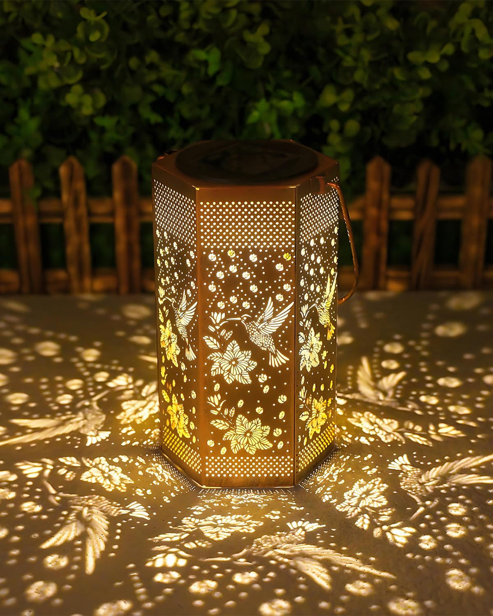 Opjoy hummingbird solar lantern in garden glows warmly for outdoor evenings.
