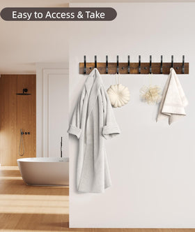 Optish wall mounted coat rack installed in a hallway entryway.