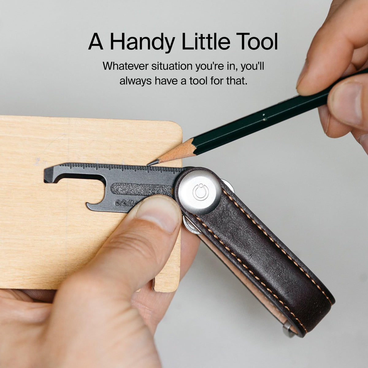 Orbitkey Multi-Tool V2 Black used to open a package quickly.
