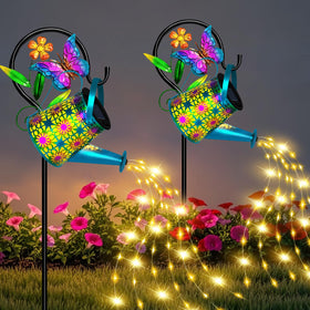 ostritec solar watering can lights illuminate a patio path with warm ambience.