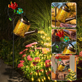 Ostritec Watering Can Lights on a Shepherd Hook extend warm ambiance along paths.