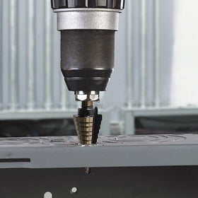 OSTTE step drill in use on metal for clean, accurate holes.
