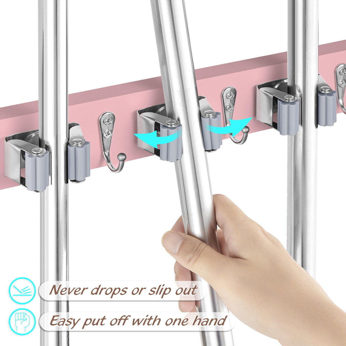 Close-up of pink wood panel with stainless steel clips securing mop handles