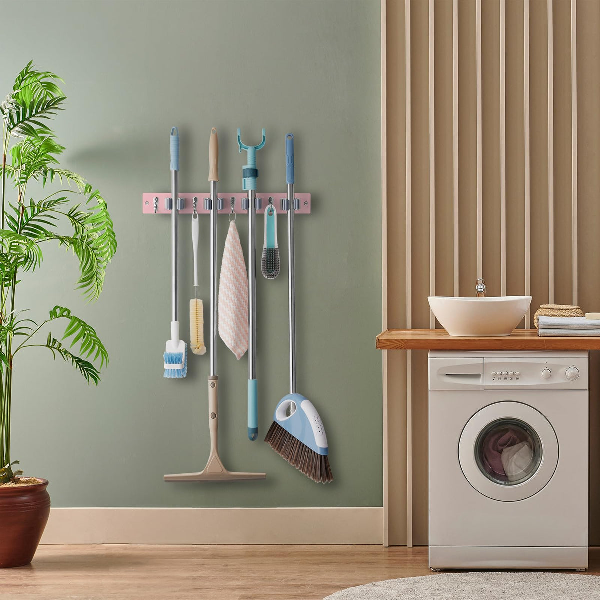 Wall mounted cleaning tool organizer in pink accent for pantry or laundry area