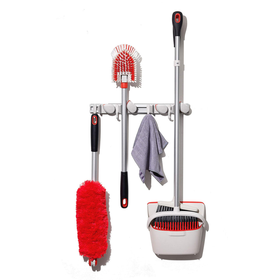 OXO Good Grips wall-mount organizer for mop and broom keeps tools organized and accessible.