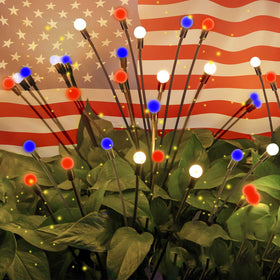 OZS 4pack solar American flag lights illuminating a patriotic backyard display