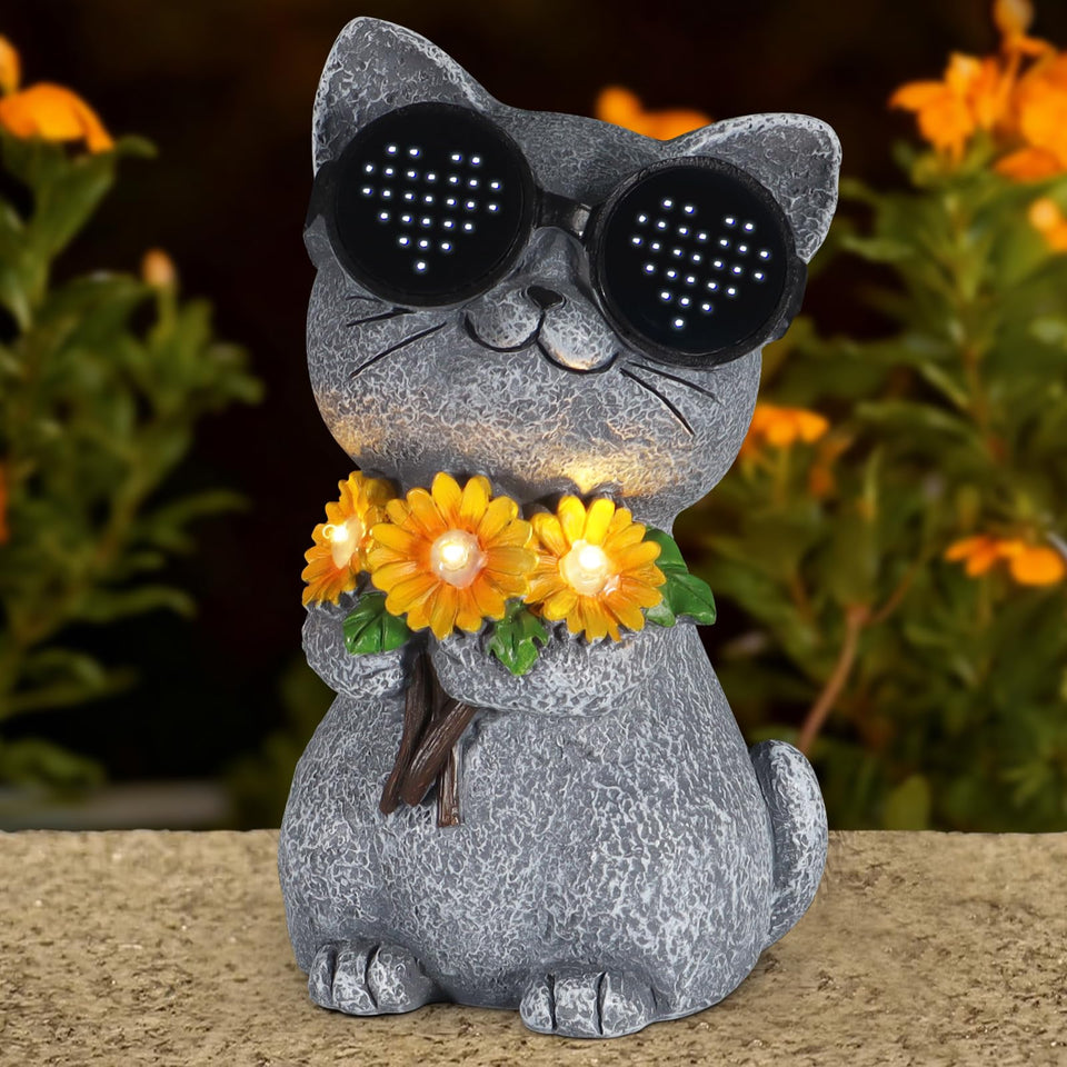 Pawatee cat daisy solar statue glows softly, adding outdoor charm.