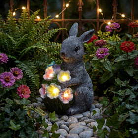 PETAFLOP solar rabbit bouquet glow illuminates garden paths at dusk.