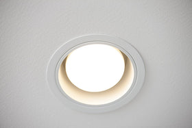 Close-up of Philips BR30 LED bulb with E26 base in focus.