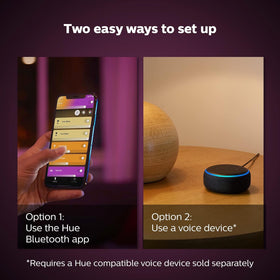 Philips Hue Bloom turned-on table lamp casting a soft glow.