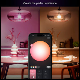 Philips Hue Essential bulb with E26 base installed in a modern lamp.