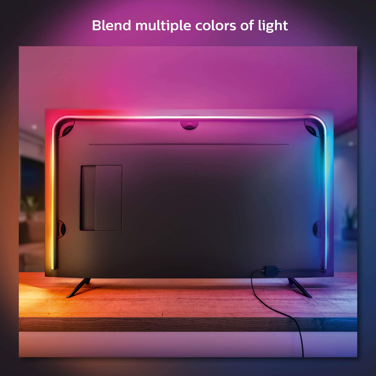 Philips Hue Play Gradient 55-inch strip mounted with brackets on the TV.