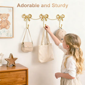 Pipigaty gold bow wall hanger; sturdy for towels and robes.