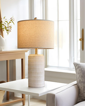 PoKat bedside lamp on a nightstand enhances decor.