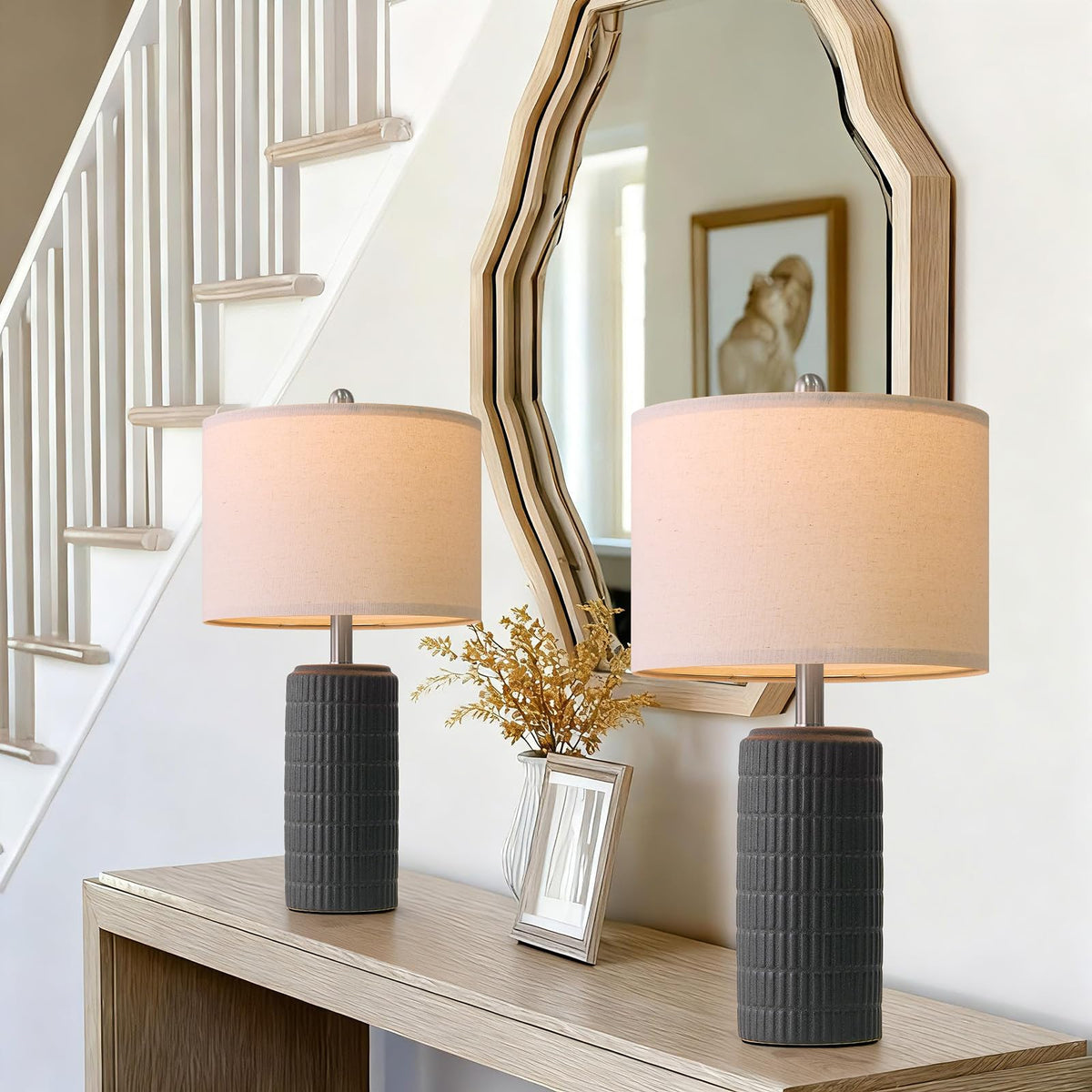 Pokat bedside lamps on a dark nightstand creating warm ambiance.
