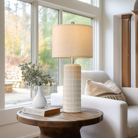 White and gold PoKat lamp complements contemporary decor.