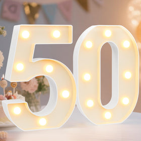 Pooqla 50-number light table decor for a bright 50th celebration