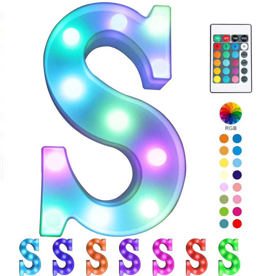 Pooqla Colorful marquee letter S LED light glowing on a shelf for colorful room decor.