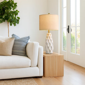 Portres nightstand lamp casting warm ambient light.