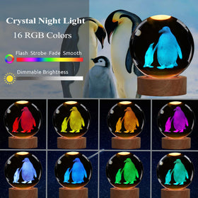 POSSHE Penguin Night Light glows through the glass sphere for warm room lighting.