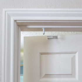 Predictable Solutions GlideLok door-frame installation screw visible for secure mounting.