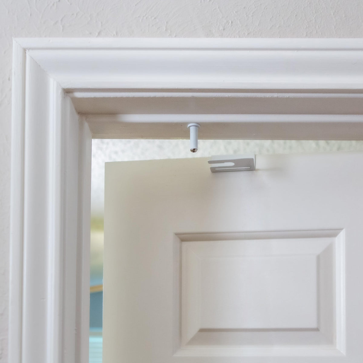 GlideLok installed on a door top for dual‑sided access by adults