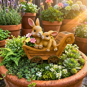 PRETMANNS bunny statue on porch with flowers creates cozy yard vignette.