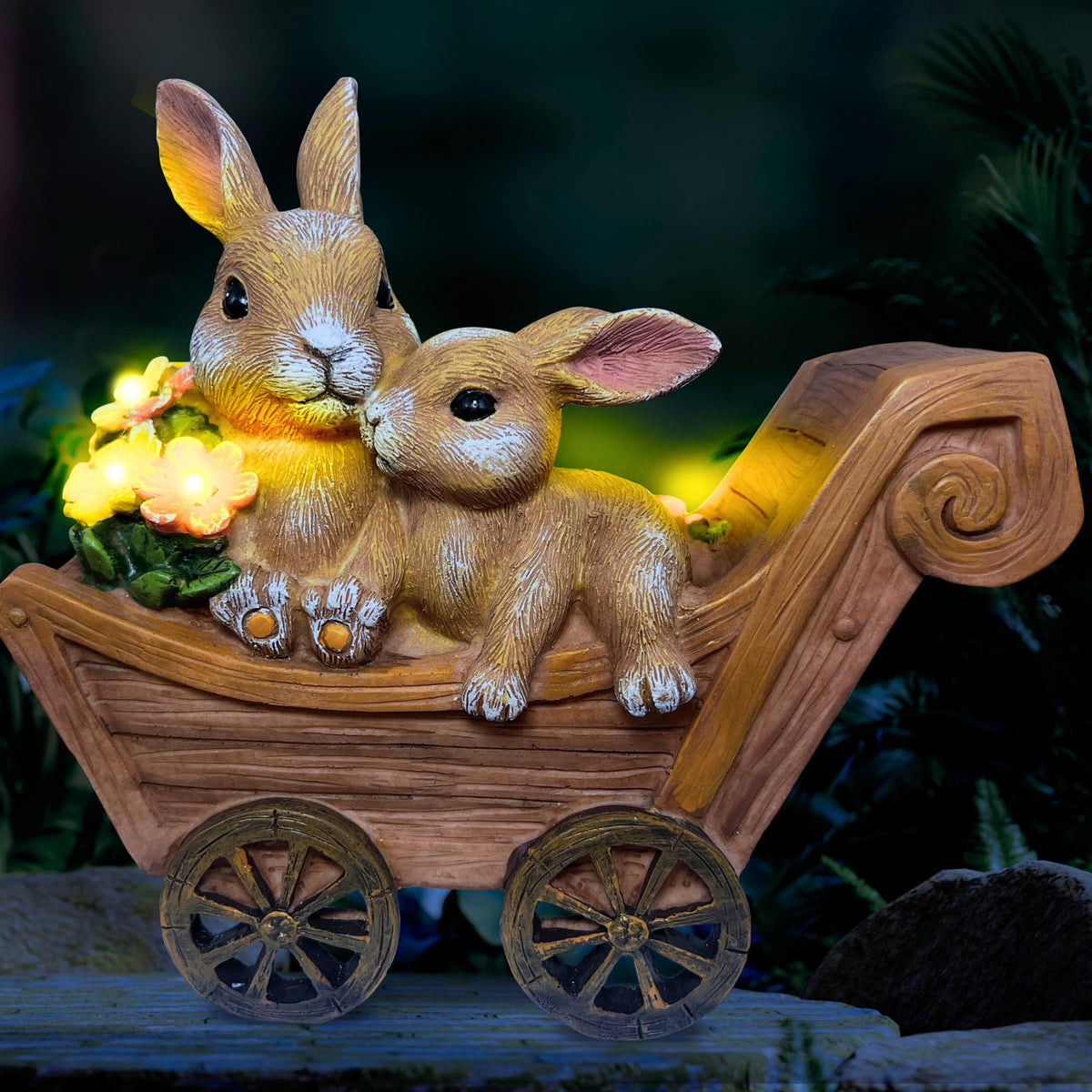 PRETMANNS Solar Bunny statue glowing in the garden at dusk.