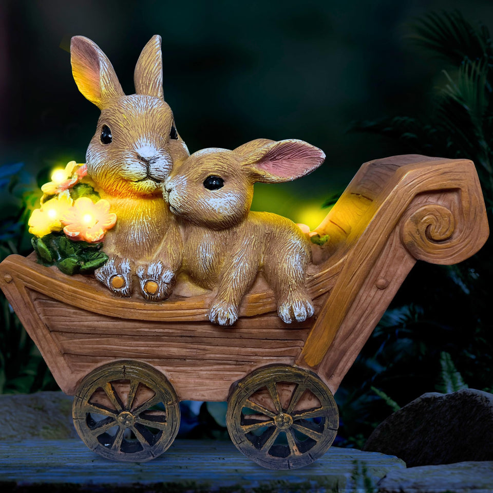 PRETMANNS Solar Bunny statue glowing in the garden at dusk.