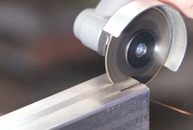 Proxxon 60-grit grinding disc attached for precise metal finishing.