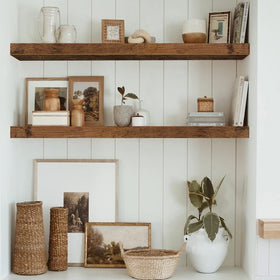 QEEIG wall-mounted shelves showing sturdy steel brackets in use