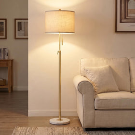 Qingmiao gold floor lamp with marble base for stable, elegant lighting in living spaces.