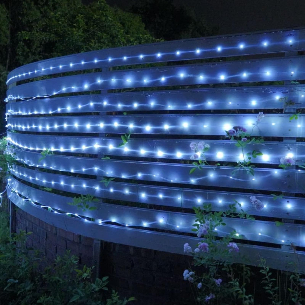 QITONG bendable rope light shapes along fence for festive glow.